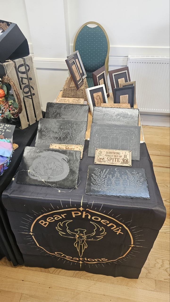 Engraved slate pieces displayed on the Bear Phoenix Creations stall