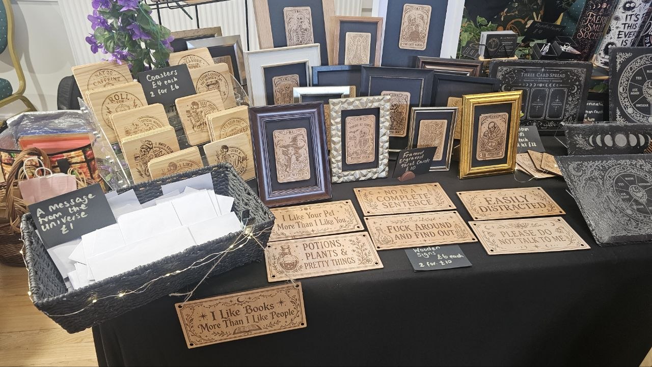 A layered display of Bear Phoenix Creations framed cards, signs and engraved pieces